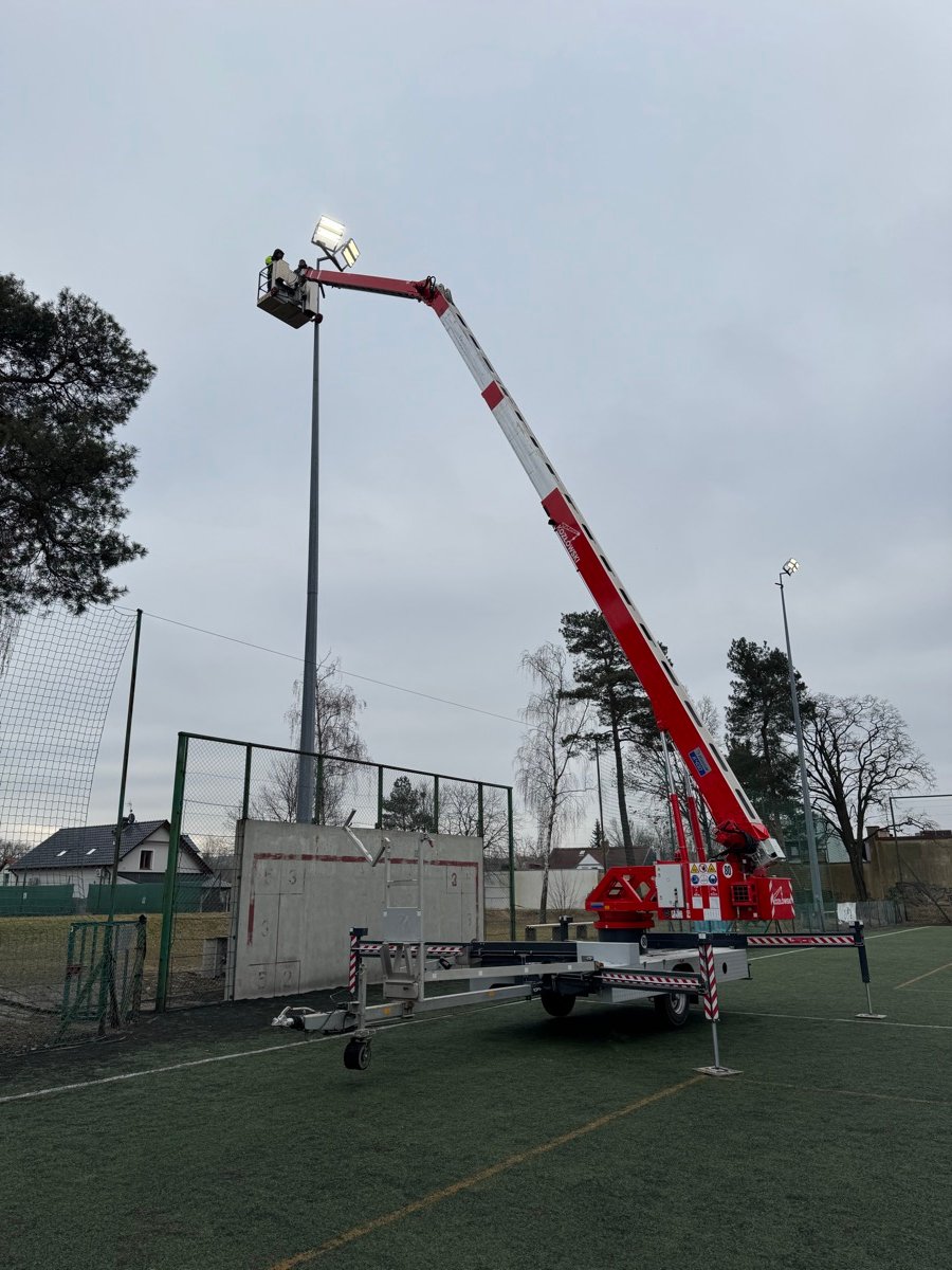 Man basket at stadium floodlights during maintenance