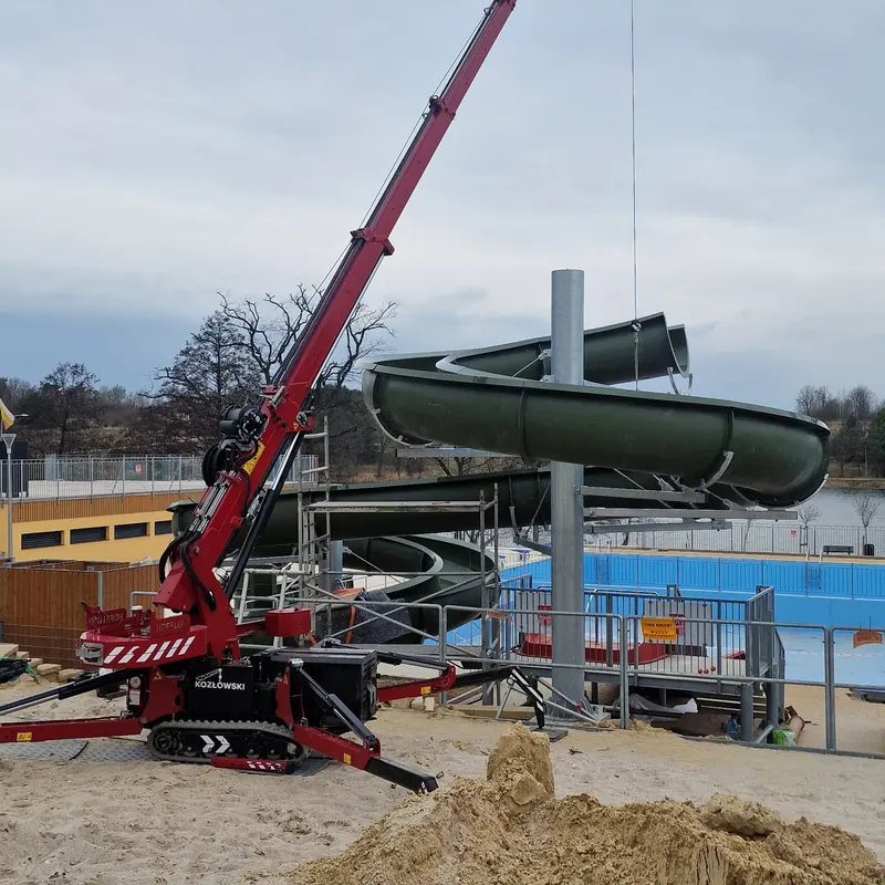 Compact crane assembling a water park slide